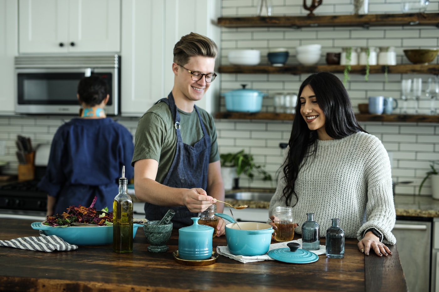 Two chefs working together in a warm kitchen